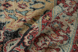 Distressed vintage Oushak rug close-up: low pile, cherry red, teal, and gold curvilinear pattern.