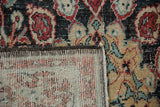 Distressed Oushak rug, showing its worn pile, woven foundation, and side cord selvage.