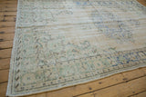 Distressed Oushak texture with mostly even wear, revealing ivory, seafoam green, and pale blue.