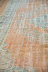 Textured distressed Oushak rug pile, showing even wear with tangerine orange and seafoam.