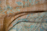 Distressed Oushak texture displaying worn pile with pale tangerine, seafoam green, and royal blue.