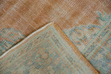 Tangerine Oushak rug with distressed pile showing faint foundation, plus striped hand-knotted reverse.