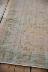 Detail of distressed Oushak rug showing worn pile, faint foundation, and intact side selvage.