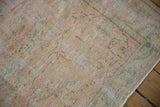 Faded texture of a vintage Oushak rug, showing even pile wear and soft distressed colors.