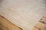 Distressed vintage Oushak carpet with even pile wear and intact side selvage.
