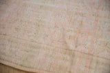 Distressed Oushak rug pile, revealing even wear, faint foundation, and muted ivory, pink, green tones.
