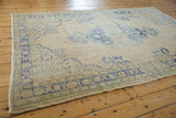 Vintage distressed Oushak rug corner, showing foundation wear, pale blue border, and intact selvage.