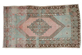 Distressed vintage Oushak rug with blush stepped medallion, muted ocean green, and palmette borders, 3'8