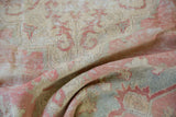 Evenly worn pile texture of a vintage distressed Oushak rug in blush and muted slate.