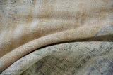 Close view of the distressed Oushak carpet's weave, showing low pile worn to the hand-knotted foundation.