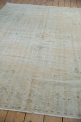 Distressed Oushak rug pile in beige and ivory, revealing mostly even wear.