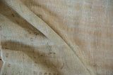 Distressed vintage Oushak rug texture, showing low pile, knot heads, and visible foundation.