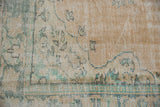 Mostly even wear and cross-hatch foundation on a distressed Oushak rug in beige, seafoam.