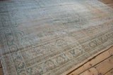 Distressed Oushak carpet with mostly even wear, exposed foundation, and intact side selvage.
