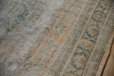 Distressed Oushak rug detail: mostly even wear to knot heads, faded green, sandalwood patterns.