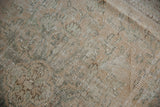 Worn knot heads and visible foundation on vintage Oushak carpet pile, with muted sage and sandalwood tones.