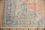 Distressed Oushak rug with faded dusty blush field and geometric blue, mint green border.