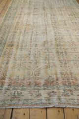 Distressed vintage Oushak rug fringe and lower border, showing worn pile and faded geometric design.