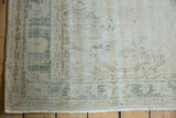 Distressed Oushak pile with mostly even wear, foundation showing. Faded green and ivory, with selvage and fringe.