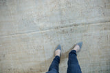 Distressed vintage Oushak rug texture, showing wear to foundation, ivory, mint, and coffee tones.