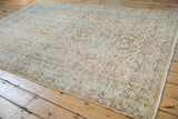 Distressed vintage Oushak rug showcasing faded vinery and pile wear exposing foundation.
