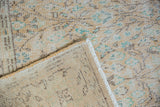 Vintage Distressed Oushak corner revealing worn pile, woven foundation, and white fringe.
