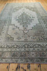 Distressed Oushak rug end border, muted gray and antique ivory geometric patterns, short fringe.