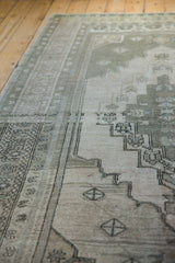 Distressed Oushak carpet pile detail, showing stepped medallion, gray, and antique ivory.