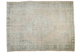 Distressed Oushak carpet, featuring a faded beige and ivory field with soft teal palmette borders, 6'3