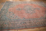 Distressed Oushak rug with even wear revealing pale blush field and aqua border.