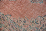 Distressed vintage Oushak rug, worn pale blush pile showing faint foundation, with aqua patterns.