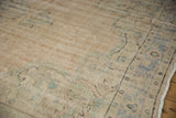 Distressed vintage Oushak carpet pile with even wear and faded blue motifs.