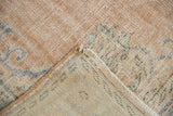 Distressed texture of vintage Oushak rug, showing worn knot heads and hand-knotted foundation.