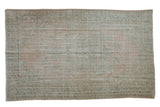 Distressed vintage Oushak rug with faded blush and mint green floral medallion, 5'11