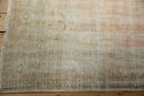 Distressed texture and faded pale rose, beige tones on Oushak carpet selvage.