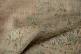 Distressed Oushak rug pile in beige, mint green, and brown with visible even wear.