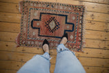 Distressed Anatolian rug, faded central gul medallion, dusty rose abrashed field.
