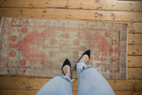Distressed vintage Oushak runner with faded terracotta, ivory, and soft coffee tones.
