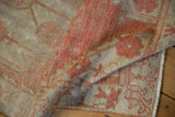 Distressed vintage Oushak rug runner showcasing faded terracotta pile and visible foundation.
