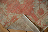 Distressed Oushak rug pile, hand-knotted reverse, white fringe, and bronze selvage.
