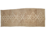 Distressed vintage Oushak runner, minimalist stepped diamond medallions on abrashed ivory and beige.