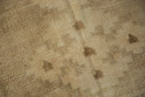 Distressed vintage Oushak rug pile with primitive geometric patterns, abrashed ivory, beige, and a weave line.