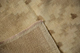 Distressed vintage Oushak rug pile and reverse weave with intact pink side cord selvage.