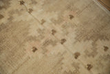 Distressed pile and faded geometric pattern on a vintage Oushak rug.