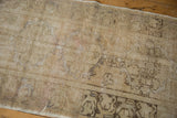 Vintage distressed Oushak runner's textured pile with faded patterns and natural wear.
