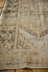 Distressed Oushak rug runner shows soft sand, ivory tones and worn texture.