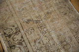 Distressed vintage Oushak runner displaying sand and brown Rococo floral motifs with even wear to knot heads.