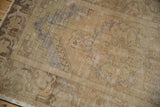Vintage distressed Oushak rug runner with soft sand tones, faded patterns, and visible low pile wear.