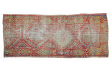 Vintage distressed Oushak runner, diamond medallion, geometric motifs in muted red, blue, yellow.