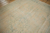 Distressed texture of vintage Oushak rug showing worn knot heads, faded apricot, ocean green.